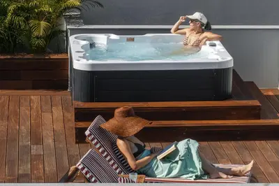 a woman in a bath tub with a woman laying in it at Casa Tabaibo by An Island Apart in Funchal