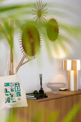 a room with a table with a bag on a wall at Casa Tabaibo by An Island Apart in Funchal