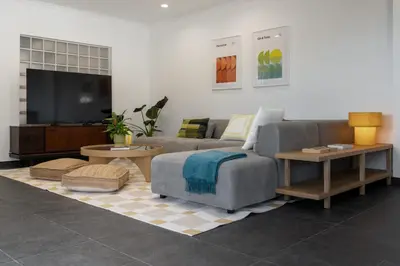a living room with a couch and a flat screen tv at Casa Tabaibo by An Island Apart in Funchal