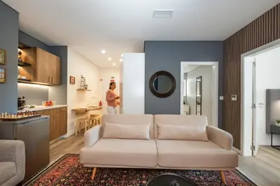 a living room with a white couch and a kitchen at Carmo in Funchal