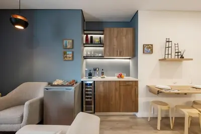 a small kitchen with a counter and a table at Carmo in Funchal