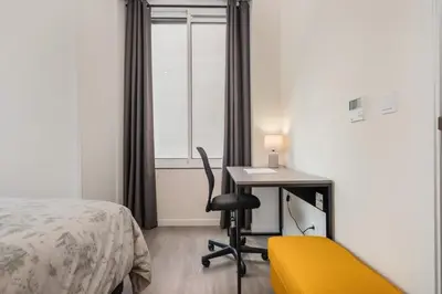 a bedroom with a desk and a bed and a yellow chair at Carmo in Funchal