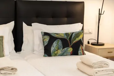 a bedroom with a bed with a black headboard and a pillow at October 5th Collection by Rent-a-key in Funchal