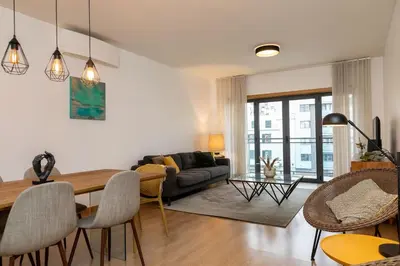 a living room with a table and a couch at October 5th Collection by Rent-a-key in Funchal