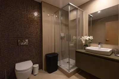 a bathroom with a shower and a toilet and a sink at October 5th Collection by Rent-a-key in Funchal