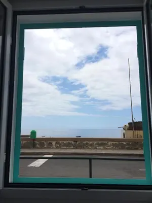 a window view of the ocean from a bus at Aqua Sea House in Madalena do Mar