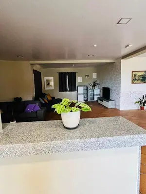 a kitchen with white cabinets and a counter top at Madeira Sunrise Villa in Gaula