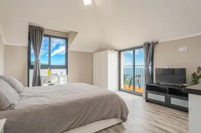 a large kitchen and living room with sliding glass doors at Madeira Sunrise Villa in Gaula
