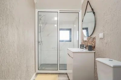 a bedroom with a bed and a tv and a window at Madeira Sunrise Villa in Gaula