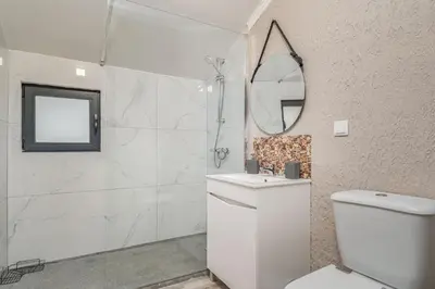 a bedroom with a bed and a desk and a tv at Madeira Sunrise Villa in Gaula
