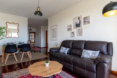 a living room with a leather couch and a table at Conde Casa Branca by LovelyStay in Funchal