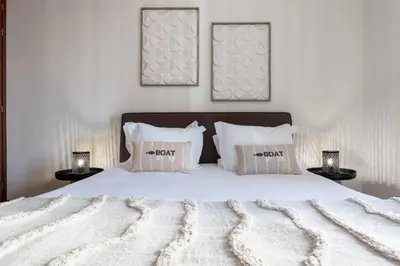 a bedroom with a large white bed with two lamps at Conde Casa Branca by LovelyStay in Funchal