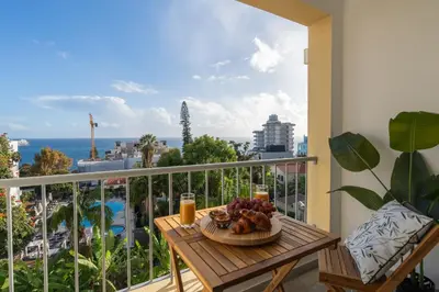 a table with a bowl of fruit on a balcony at Conde Casa Branca by LovelyStay in Funchal