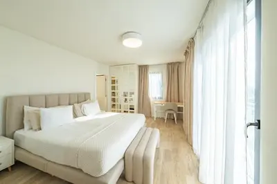 a living room with a couch and a large screen tv at Villa Infinityviews Madeira in Câmara de Lobos