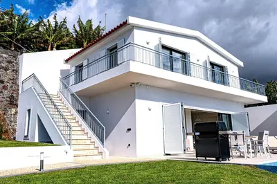 a balcony with a view of the ocean at Villa Infinityviews Madeira in Câmara de Lobos