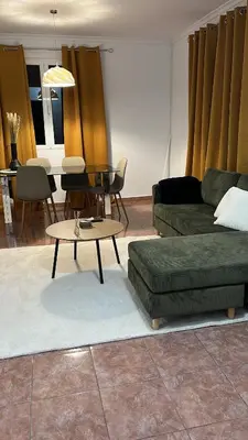 a living room with a couch and a table at Brisa do Norte apartment in São Vicente