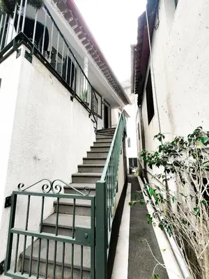a stairway with a green railing next to a building at Brisa do Norte apartment in São Vicente
