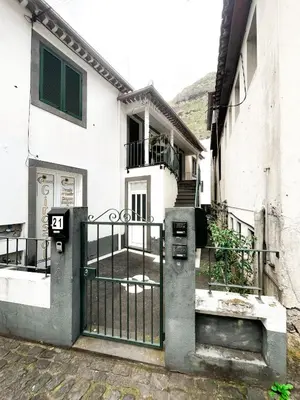 an entrance to a house with a gate at Brisa do Norte apartment in São Vicente