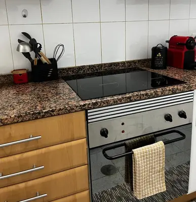 a kitchen with a stove and a counter top at Brisa do Norte apartment in São Vicente