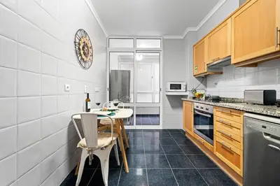 a kitchen with a table and chairs in it at Peace Haven II in Calheta