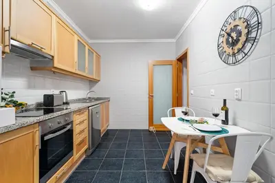 a kitchen with a table and a small table with chairs at Peace Haven II in Calheta