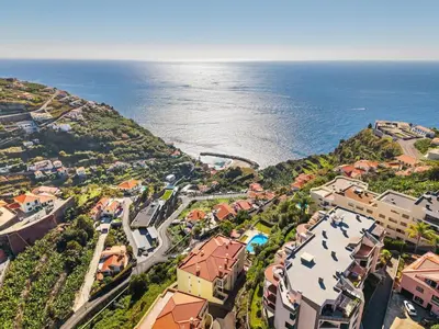 an aerial view of a town next to the ocean at Peace Haven II in Calheta