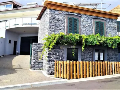 a stone house with a wooden fence in front of it at Holiday Home Casa Lugar da Ribeira mit Dachterrasse by Interhome in Campanário