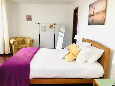 a bedroom with a bed with white sheets and pillows at Holiday Home Casa Lugar da Ribeira mit Dachterrasse by Interhome in Campanário