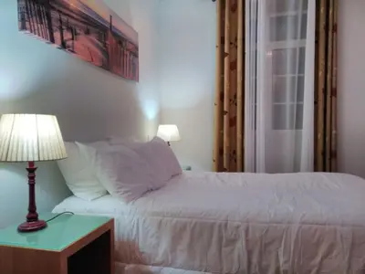 a bedroom with a bed and a lamp on a table at Holiday Home Quinta do Serrado by Interhome in Ribeira da Janela