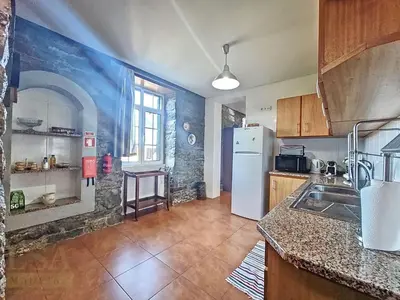 a kitchen with a refrigerator and a counter top at Holiday Home Quinta do Serrado by Interhome in Ribeira da Janela