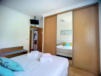 a bedroom with two beds and a mirror at Holiday Home Yohannas Unterkunft by Interhome in Campanário