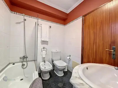 a bathroom with a toilet and a tub and a sink at Apartment Domus Dino by Interhome in Porto da Cruz