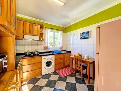 a kitchen with a washing machine and a table at Apartment Domus Dino by Interhome in Porto da Cruz