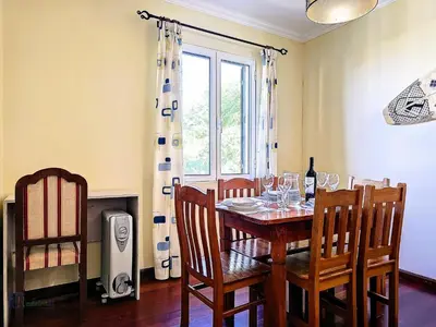 a dining room with a table and chairs and a window at Apartment Domus Dino by Interhome in Porto da Cruz