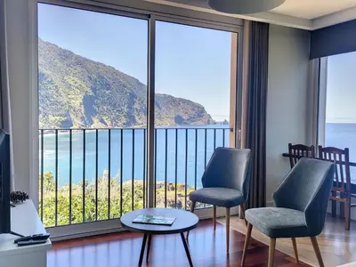 a room with a large window with a view of the ocean at Holiday Home Urlaubshaus Vier Generationen by Interhome in Seixal