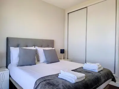 a bedroom with a large bed with towels on it at Holiday Home Urlaubshaus Vier Generationen by Interhome in Seixal