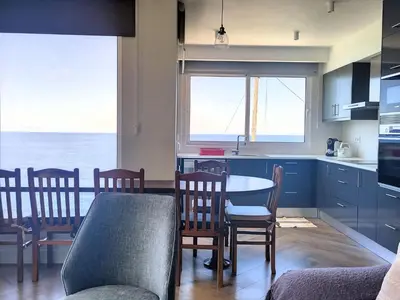 a kitchen and dining room with a table and chairs at Holiday Home Urlaubshaus Vier Generationen by Interhome in Seixal