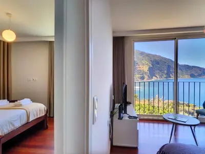 a room with a bed and a view of the ocean at Holiday Home Urlaubshaus Vier Generationen by Interhome in Seixal