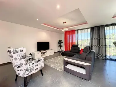 a living room with a couch and chairs and a tv at Holiday Home Traumhaus 2- von LSAMadeira by Interhome in Calheta
