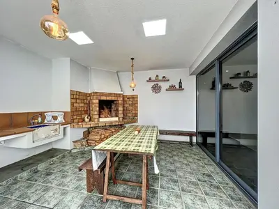 a kitchen with a table and a fireplace at Holiday Home Traumhaus 2- von LSAMadeira by Interhome in Calheta