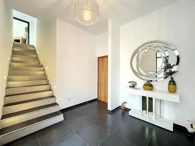 a hallway with a staircase and a round mirror at Holiday Home Traumhaus 2- von LSAMadeira by Interhome in Calheta