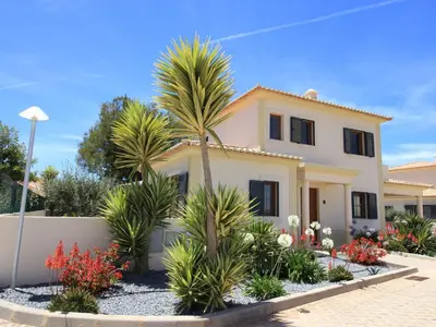 a house with palm trees in front of it at Holiday Home Vila Marques da Luz by Interhome in Montinhos da Luz