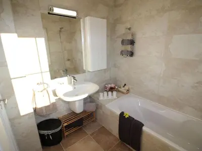 a bathroom with a sink and a tub and a toilet at Holiday Home Vila Marques da Luz by Interhome in Montinhos da Luz