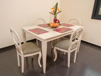 a white table with two chairs and a bowl of fruit at Holiday Home Elegantes Haus in Santana mit Garten und Grill by Interhome in Santana