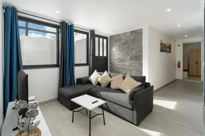 a living room with a couch and a table at OurMadeira - Casa da Vinha in Câmara de Lobos