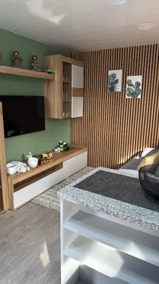 a room with a bed and a table in it at O Refúgio in Calheta