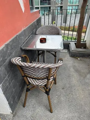 a table and a chair sitting next to a table at O Refúgio in Calheta