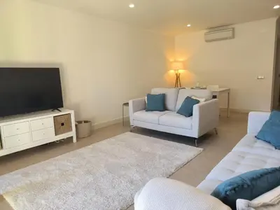 a living room with a couch and a tv at Casa Amarillo in Lagos