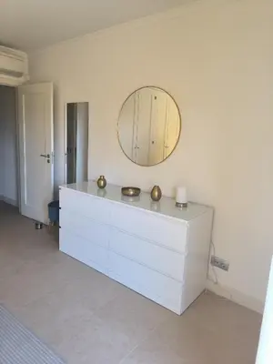 a white dresser with a mirror on the wall at Casa Amarillo in Lagos