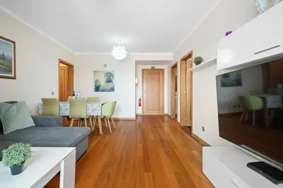 a living room with a couch and a table at Lido Retreat Apartment in Funchal
